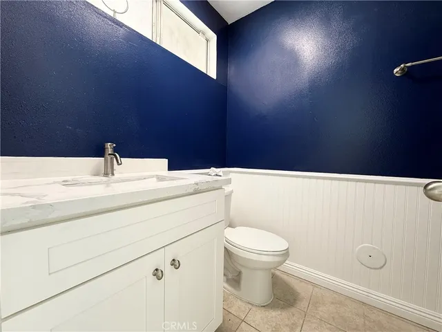 a view of a hallway with wooden floor and closet area