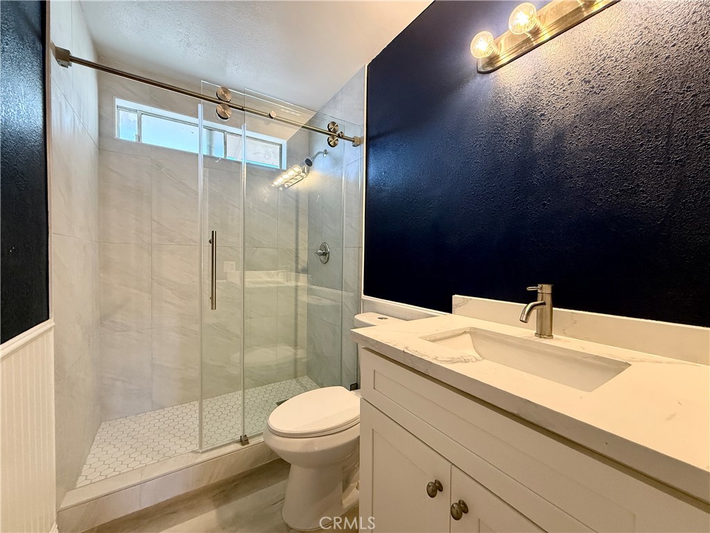 1415 Everton Place Riverside, CA 92507 - Photo 18 of 24 a bathroom with a sink toilet and shower