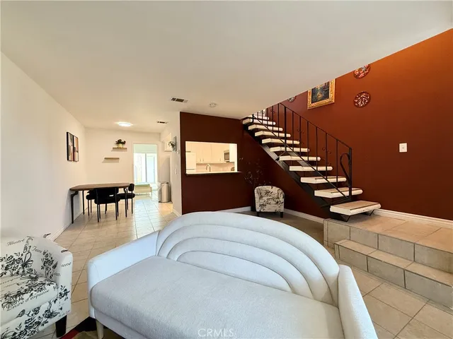 a bedroom with furniture and wooden floor