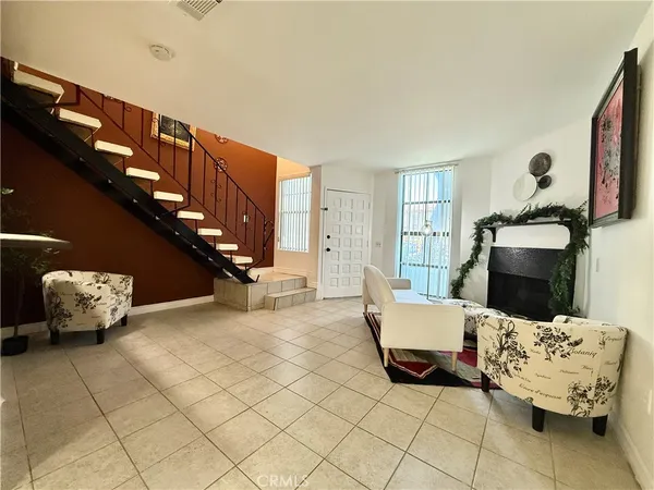 a living room with furniture and stairs