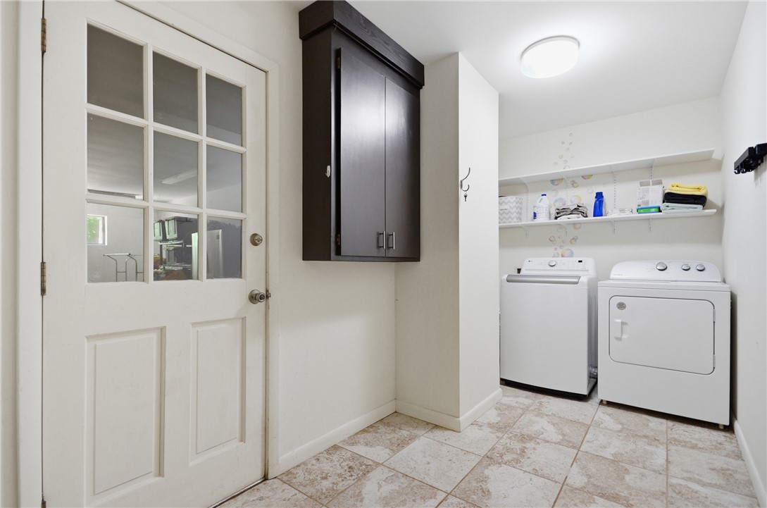 1298 Carradine Road Seneca, SC 29678 - Photo 15 of 43 Functional laundry space with a paneled door, storage cabinet, and tiled flooring.