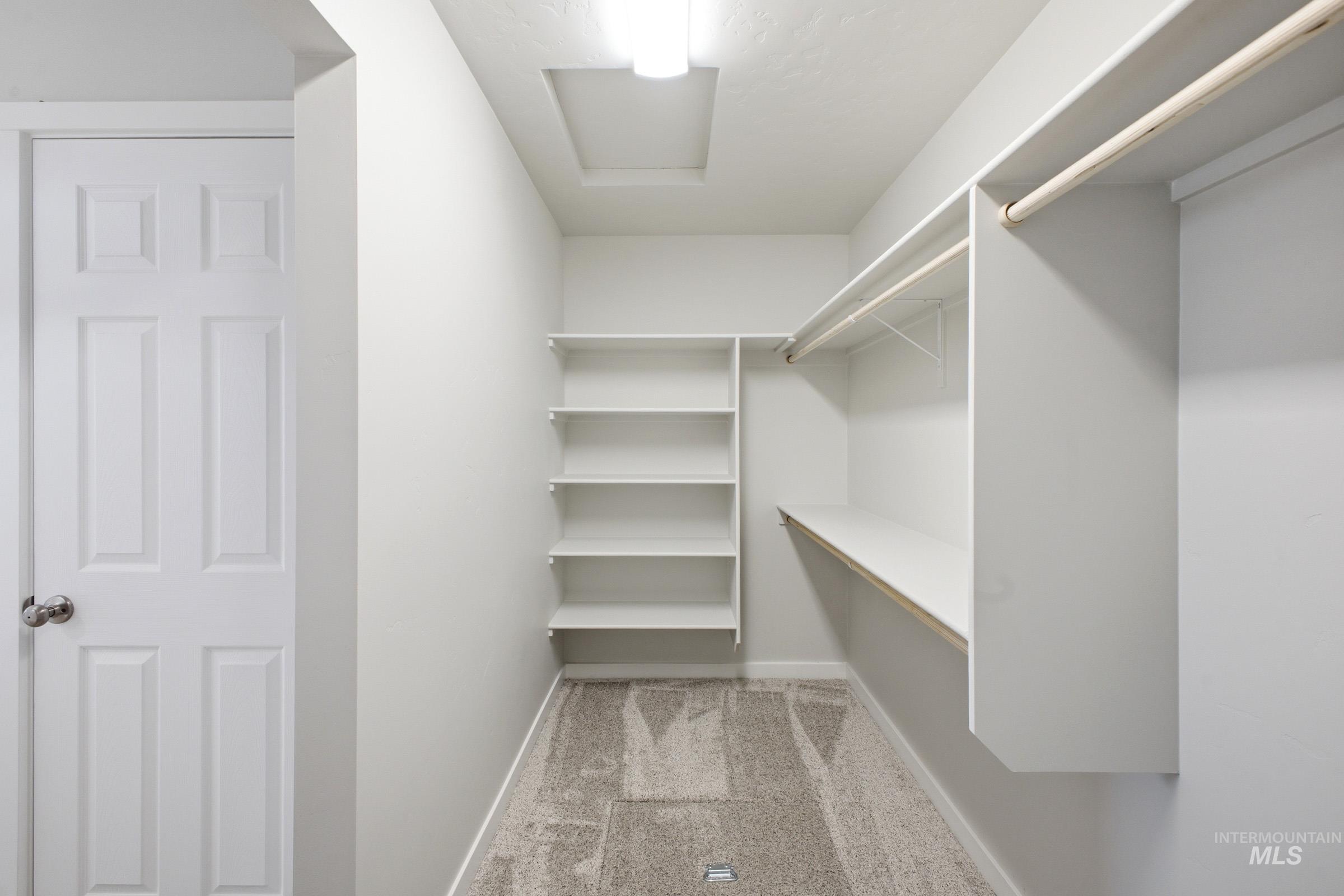 1598 Sunday River Street Middleton, ID 83644 - Photo 17 of 17 Walk-in closet featuring built-in shelving, hanging rods, and carpet flooring