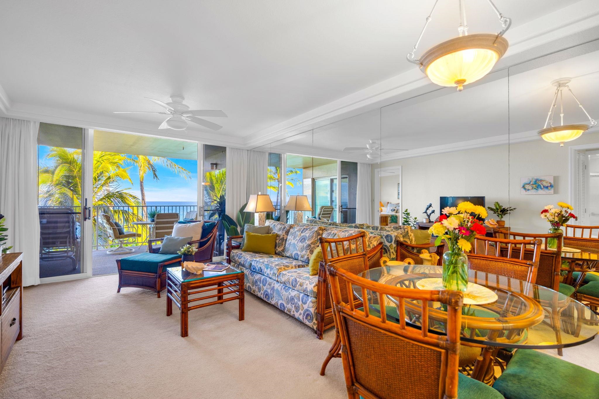 2430 South Kihei Road, Unit 515 Kihei, HI 96753 - Photo 14 of 50 a living room with furniture a chandelier and a large window