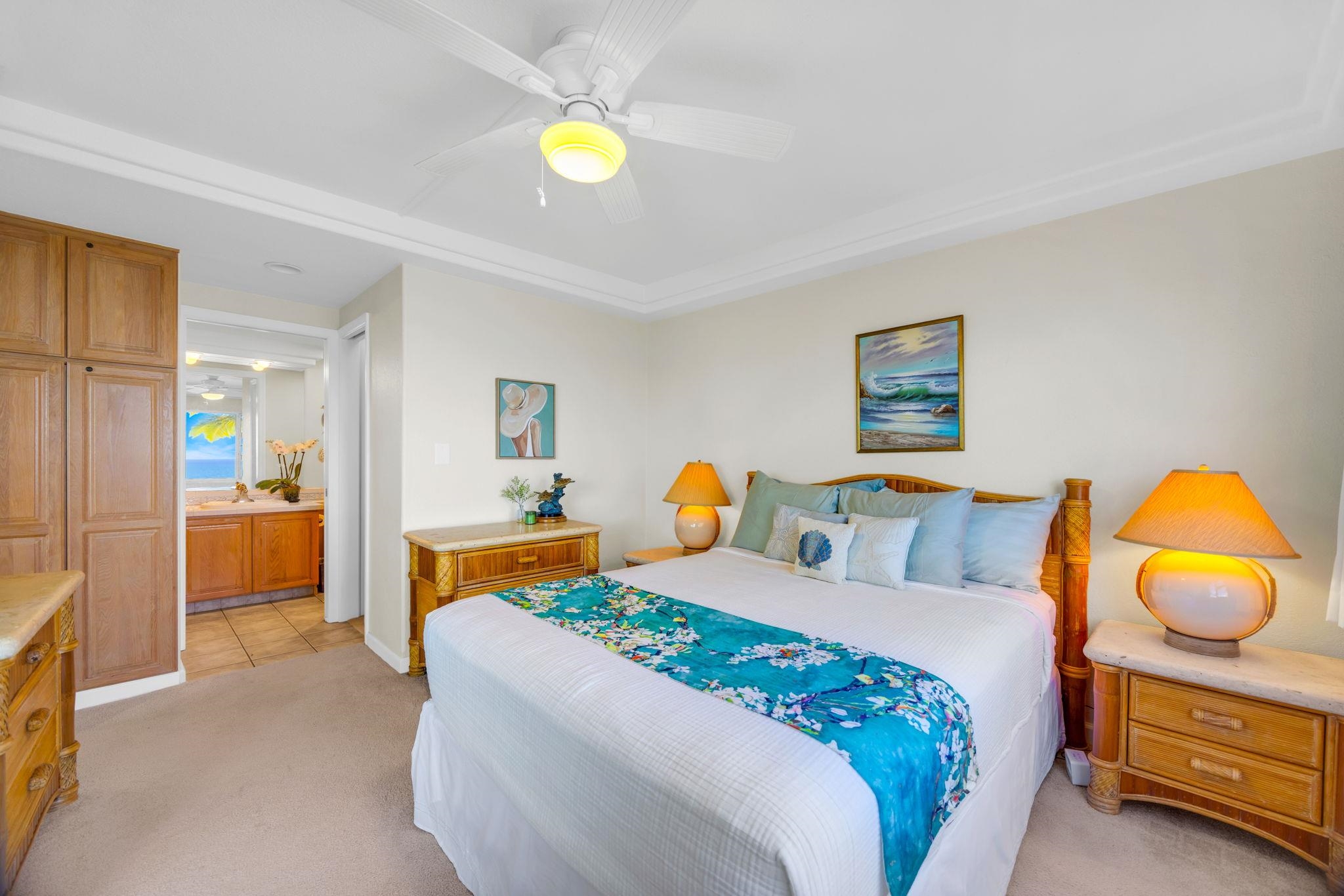 2430 South Kihei Road, Unit 515 Kihei, HI 96753 - Photo 29 of 50 a bedroom with a bed and painting on the wall