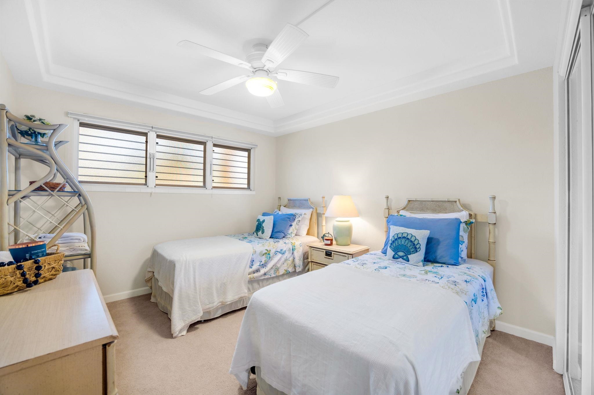 2430 South Kihei Road, Unit 515 Kihei, HI 96753 - Photo 32 of 50 a bedroom with two beds and chandelier