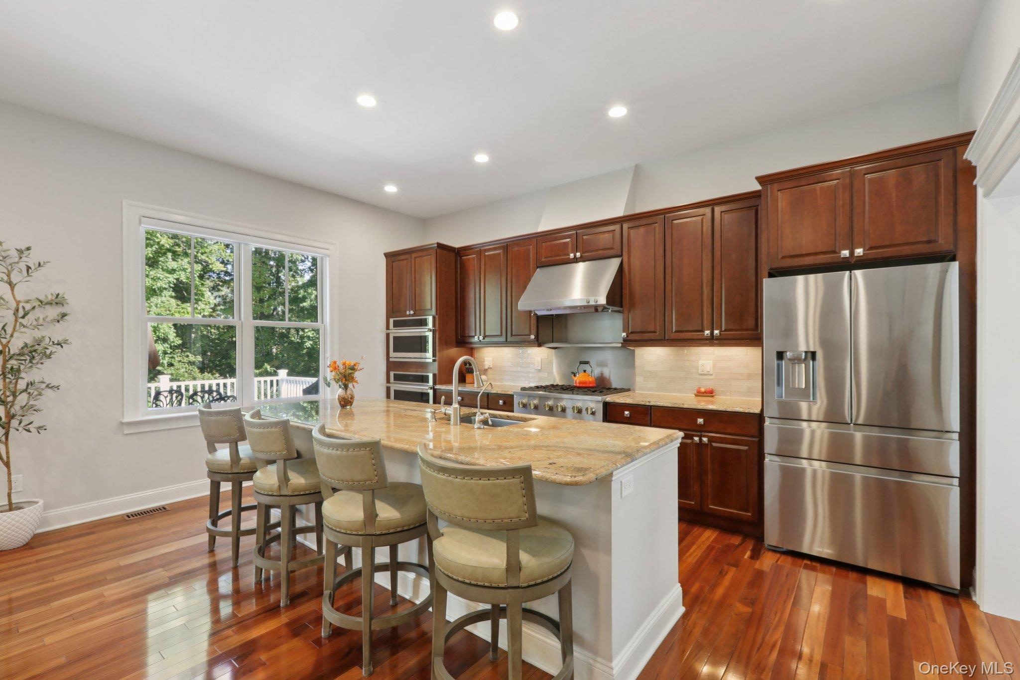 21 Long House Road Warwick, NY 10990 - Photo 20 of 50 a kitchen with refrigerator cabinets dining table and chairs