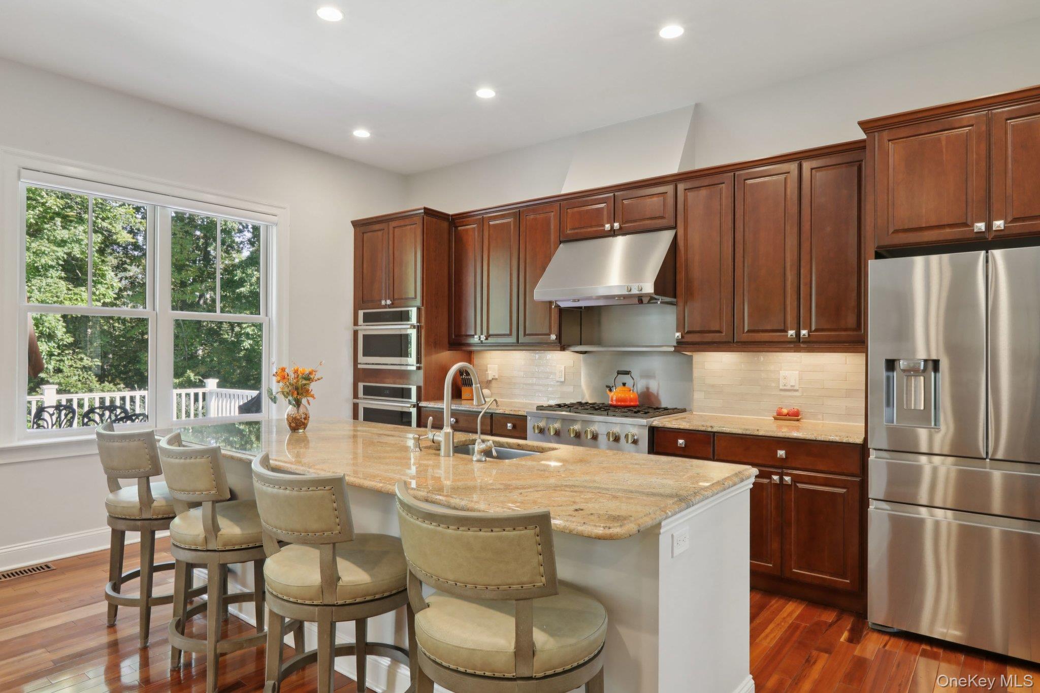 21 Long House Road Warwick, NY 10990 - Photo 21 of 50 a kitchen with stainless steel appliances a dining table chairs refrigerator and sink