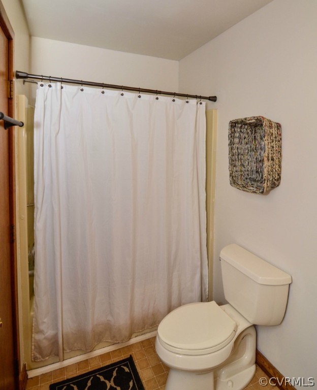 12324 Beach Road Chesterfield, VA 23838 - Photo 18 of 24 a white toilet sitting next to a shower curtain