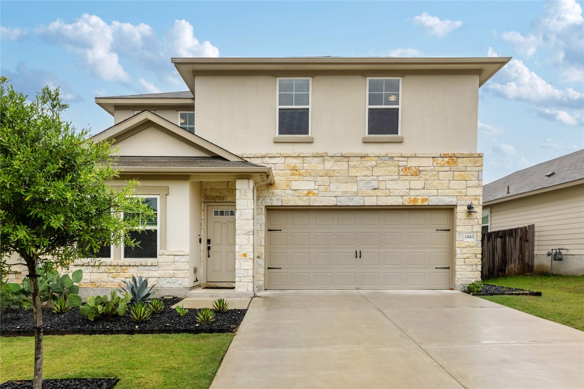a front view of a house with garden