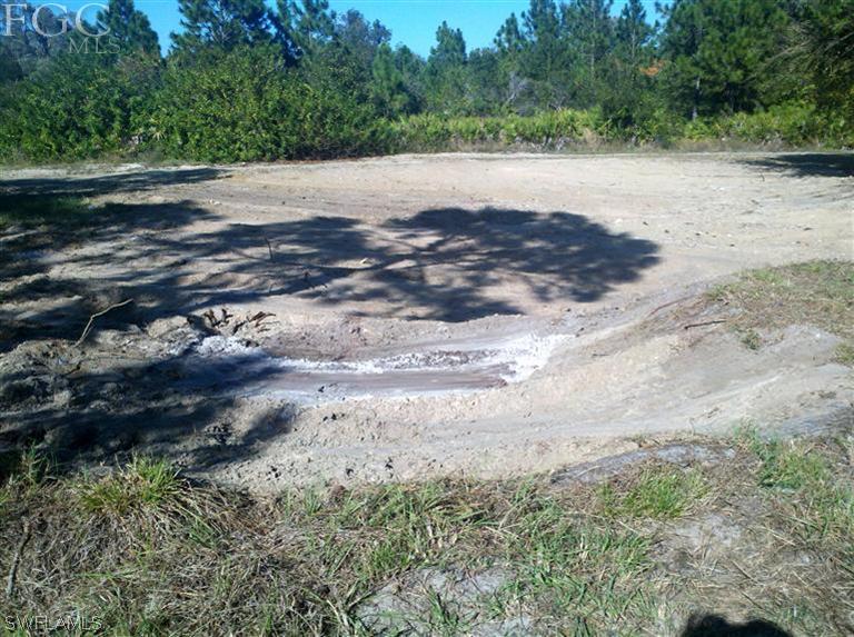 11660 Shawnee Road Fort Myers, FL 33913 - Photo 3 of 12 a view of a road with a yard
