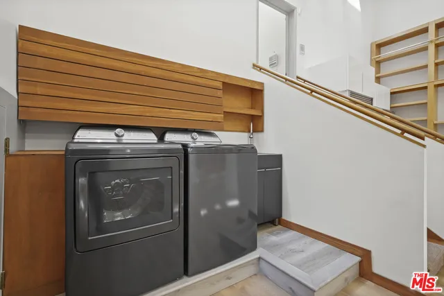 a view of a room with wooden floor and furniture