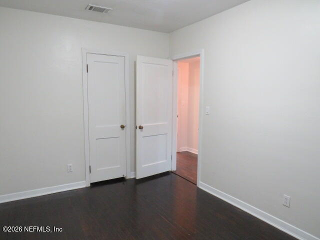 4649 Cambridge Road Jacksonville, FL 32210 - Photo 15 of 24 a view of an empty room with wooden floor