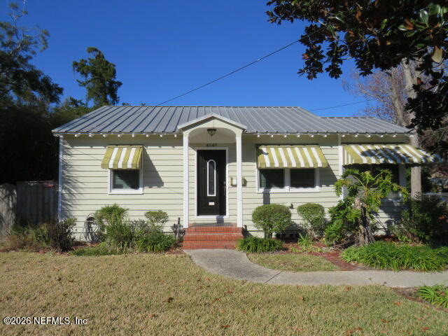 4649 Cambridge Road Jacksonville, FL 32210 - Photo 2 of 24 a front view of a house with a yard