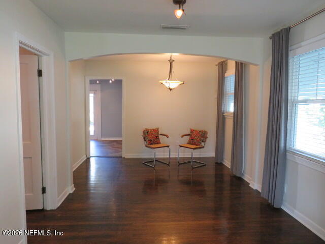 4649 Cambridge Road Jacksonville, FL 32210 - Photo 4 of 24 a view of a hallway with wooden floor and a potted plant