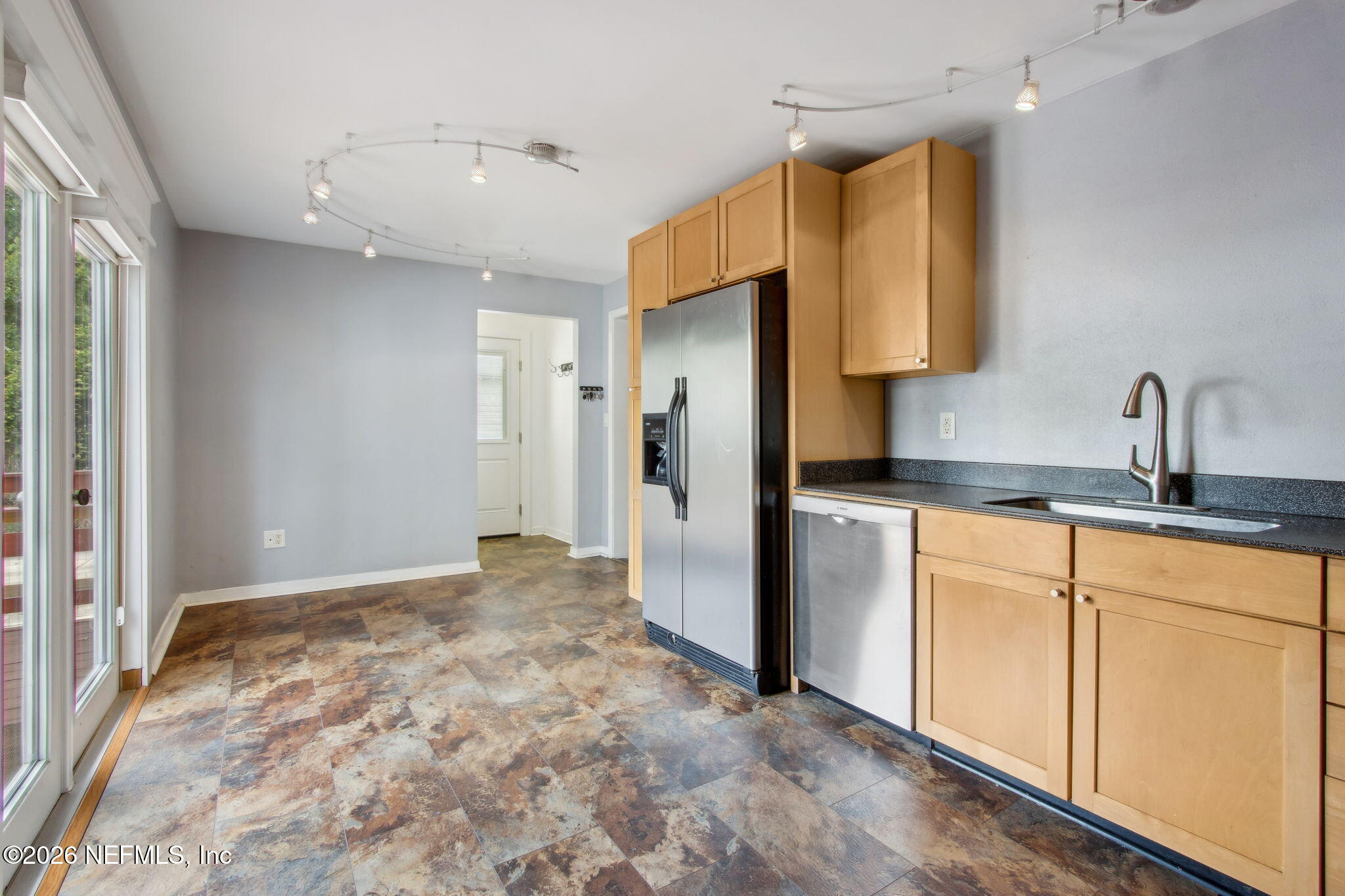 4649 Cambridge Road Jacksonville, FL 32210 - Photo 8 of 24 a kitchen with stainless steel appliances granite countertop a refrigerator and a sink