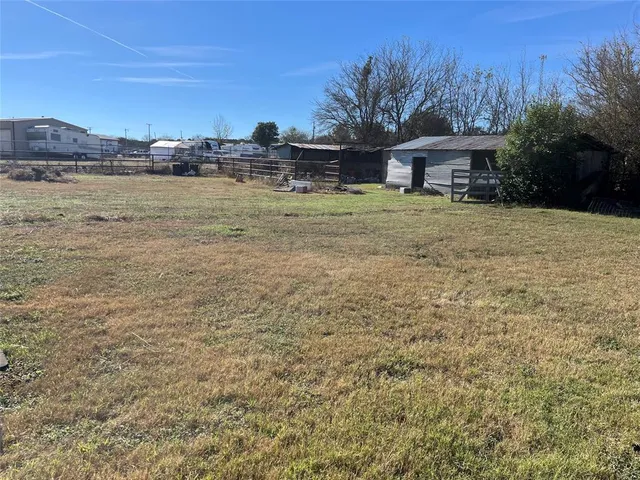 a front view of a house with a yard and mountain view in back