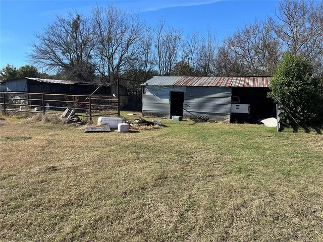 a view of house with backyard space and balcony