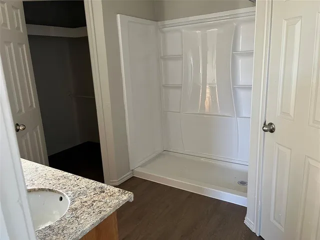 a bathroom with a tub and shower