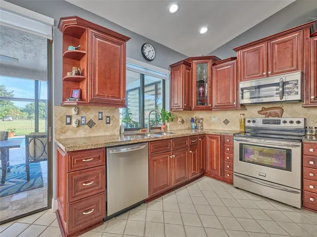 a kitchen with a sink stove and cabinets