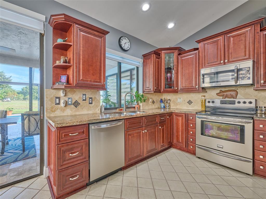 19284 Cherry Hills Terrace Boca Raton, FL 33498 - Photo 17 of 45 a kitchen with a sink stove and cabinets