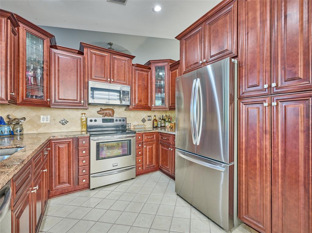 19284 Cherry Hills Terrace Boca Raton, FL 33498 - Photo 19 of 45 a kitchen with stainless steel appliances granite countertop a refrigerator sink and cabinets