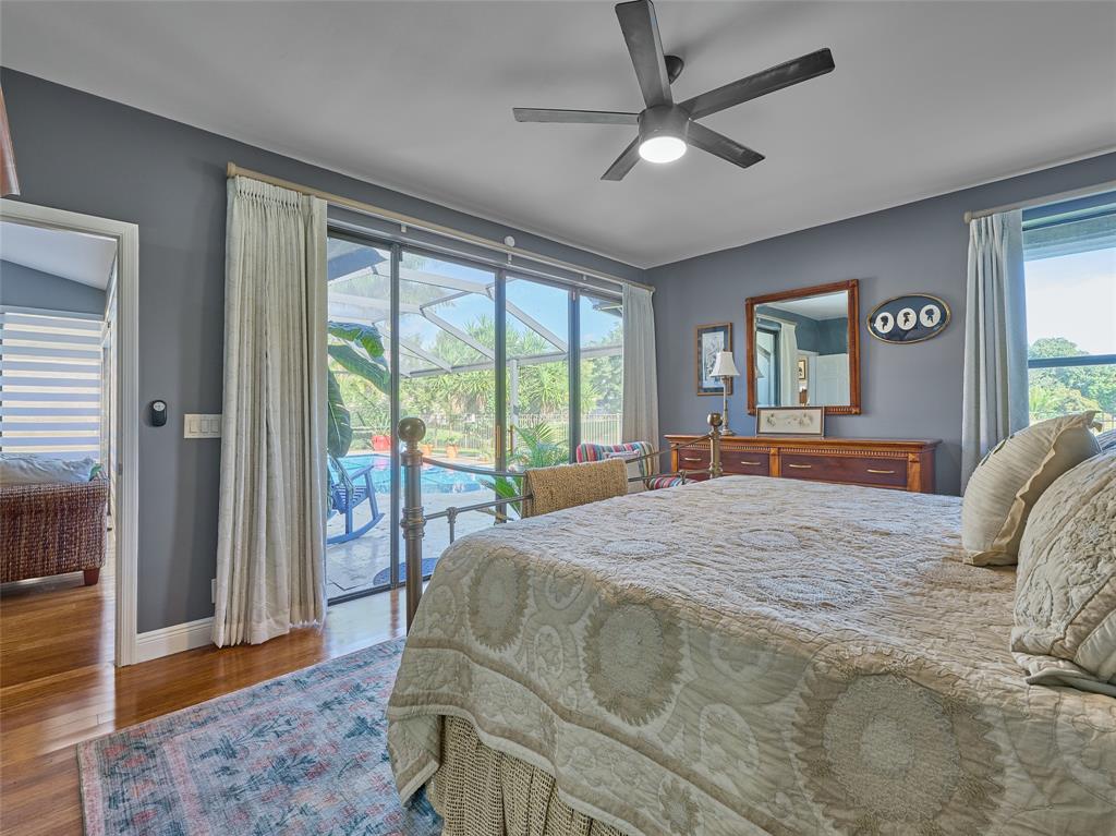 19284 Cherry Hills Terrace Boca Raton, FL 33498 - Photo 20 of 45 a bedroom with a large bed and a large window