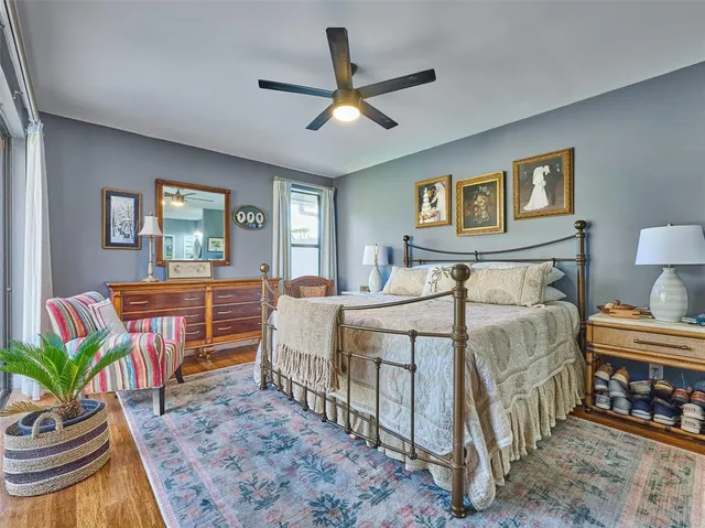 a bedroom with a bed table and a window