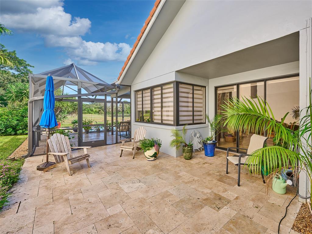 19284 Cherry Hills Terrace Boca Raton, FL 33498 - Photo 30 of 45 a building outdoor space with patio furniture and potted plants