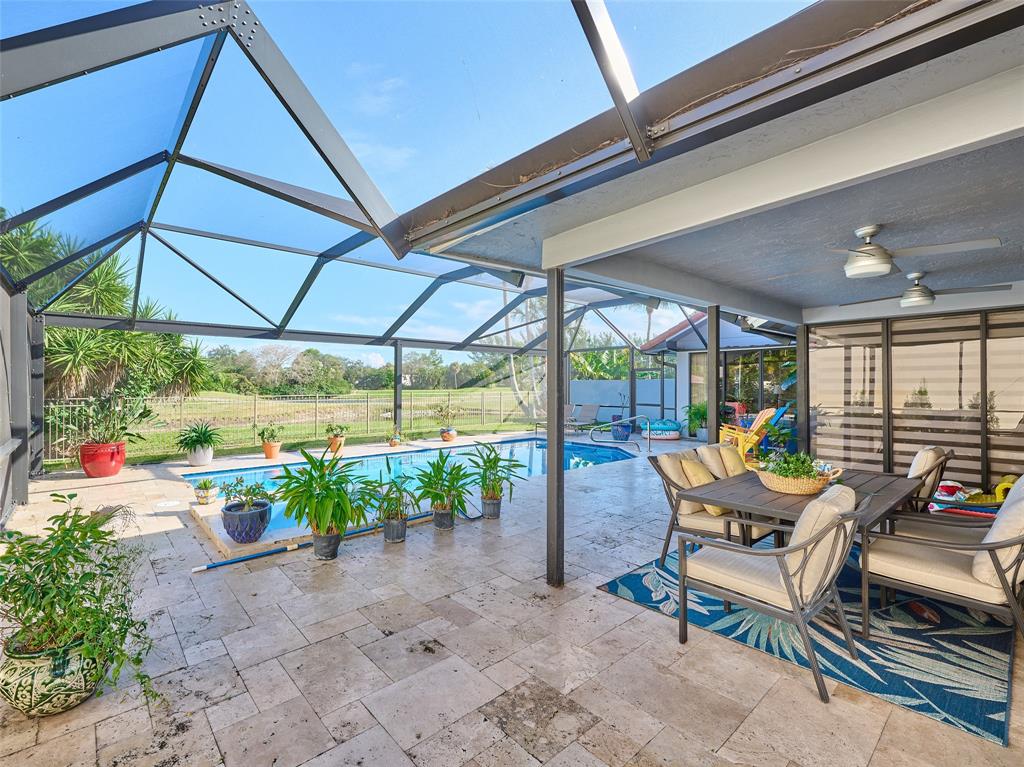 19284 Cherry Hills Terrace Boca Raton, FL 33498 - Photo 31 of 45 a backyard of a house with garden and outdoor seating