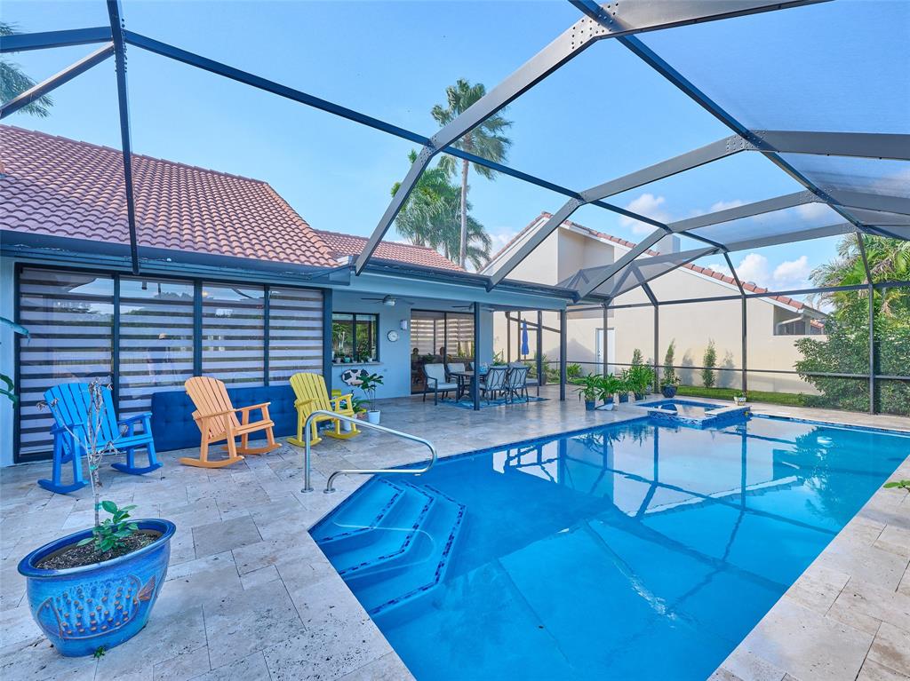 19284 Cherry Hills Terrace Boca Raton, FL 33498 - Photo 33 of 45 a view of a patio with a table and chairs