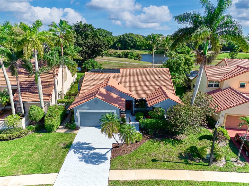 19284 Cherry Hills Terrace Boca Raton, FL 33498 - Photo 34 of 45 front view of house with a yard and potted plants