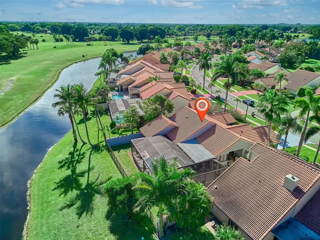 an aerial view of multiple houses with yard