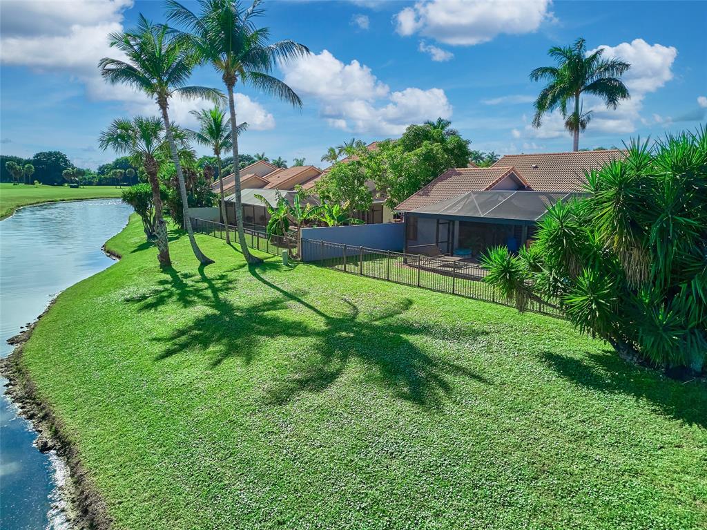 19284 Cherry Hills Terrace Boca Raton, FL 33498 - Photo 39 of 45 a garden with a tree in front of it