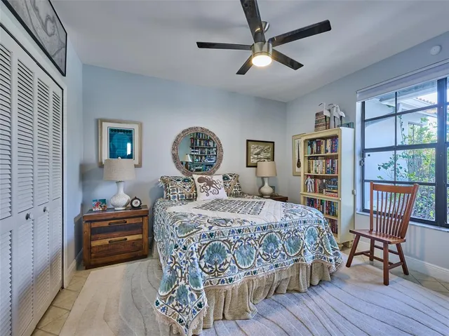 a bedroom with a bed and a book shelf