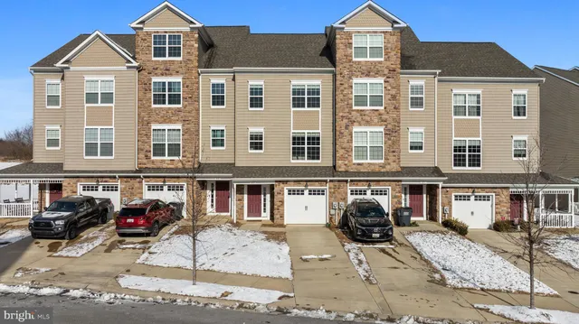 a front view of a residential apartment building with a yard