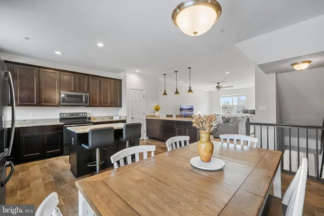 a living room with furniture a ceiling fan and a window