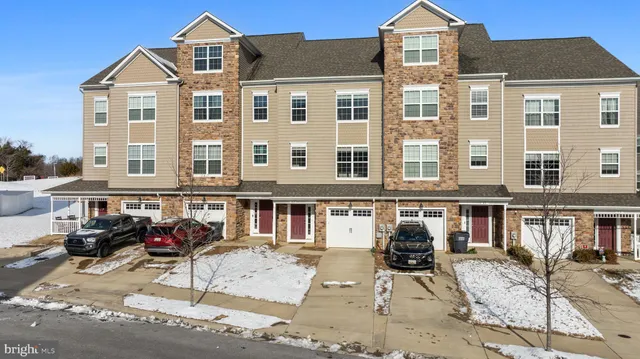 a front view of a residential apartment building with a yard