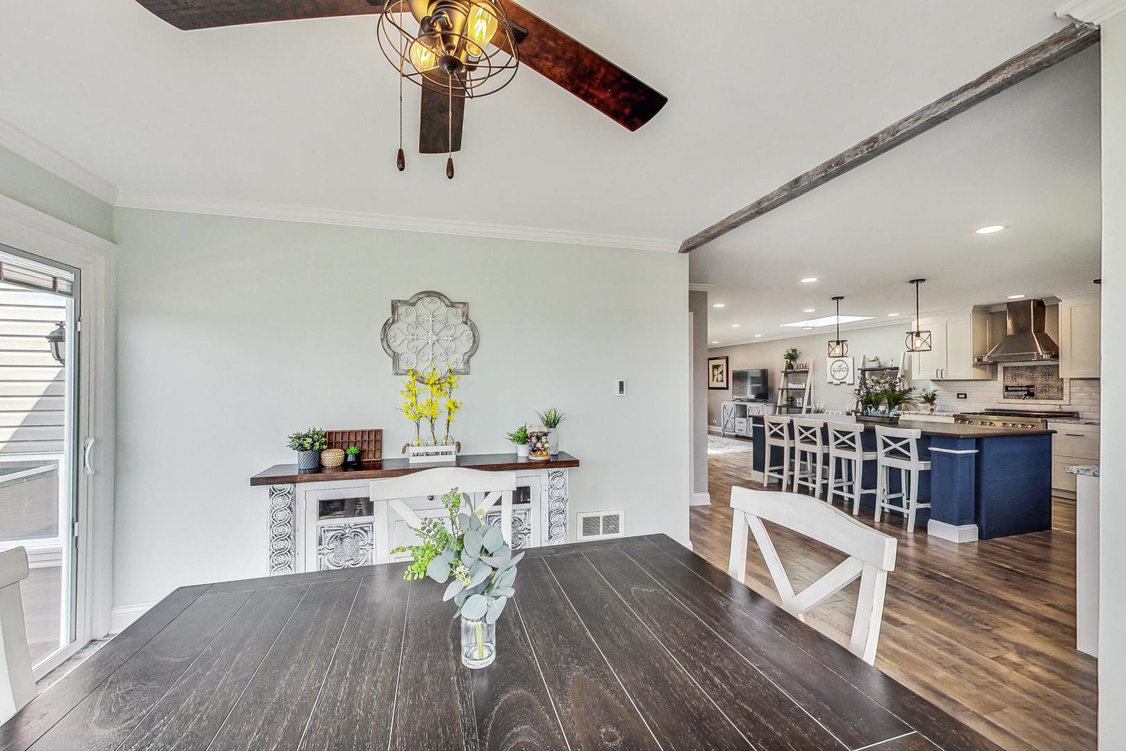 837 Foster Avenue Bartlett, IL 60103 - Photo 11 of 46 a view of a dining room with furniture a chandelier and wooden floor