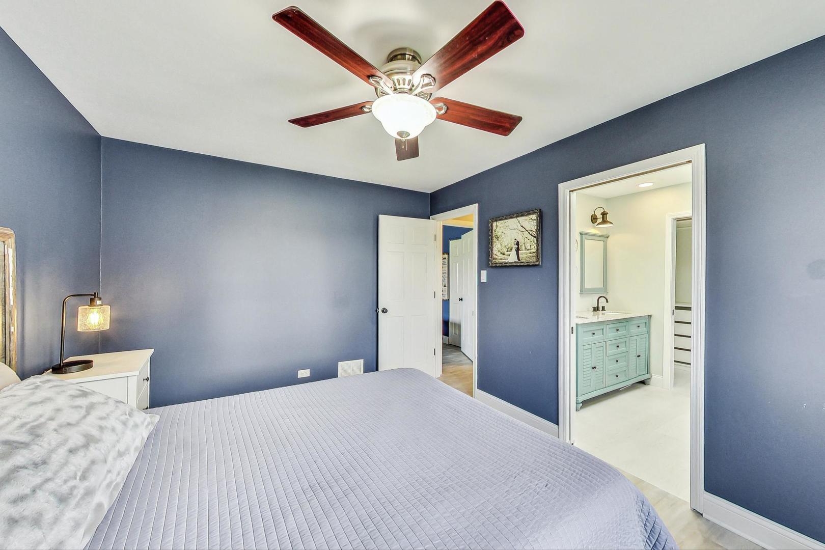 837 Foster Avenue Bartlett, IL 60103 - Photo 15 of 46 a bedroom with a bed and a large mirror