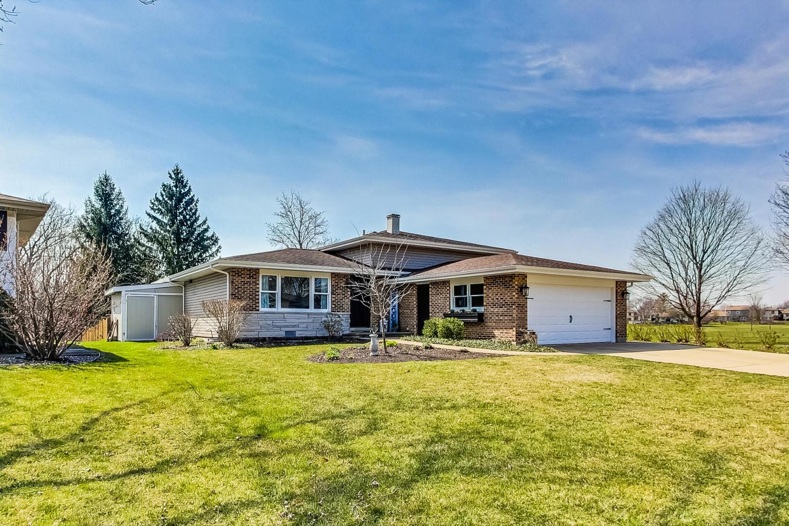 837 Foster Avenue Bartlett, IL 60103 - Photo 2 of 46 a front view of house with yard and trees in the background