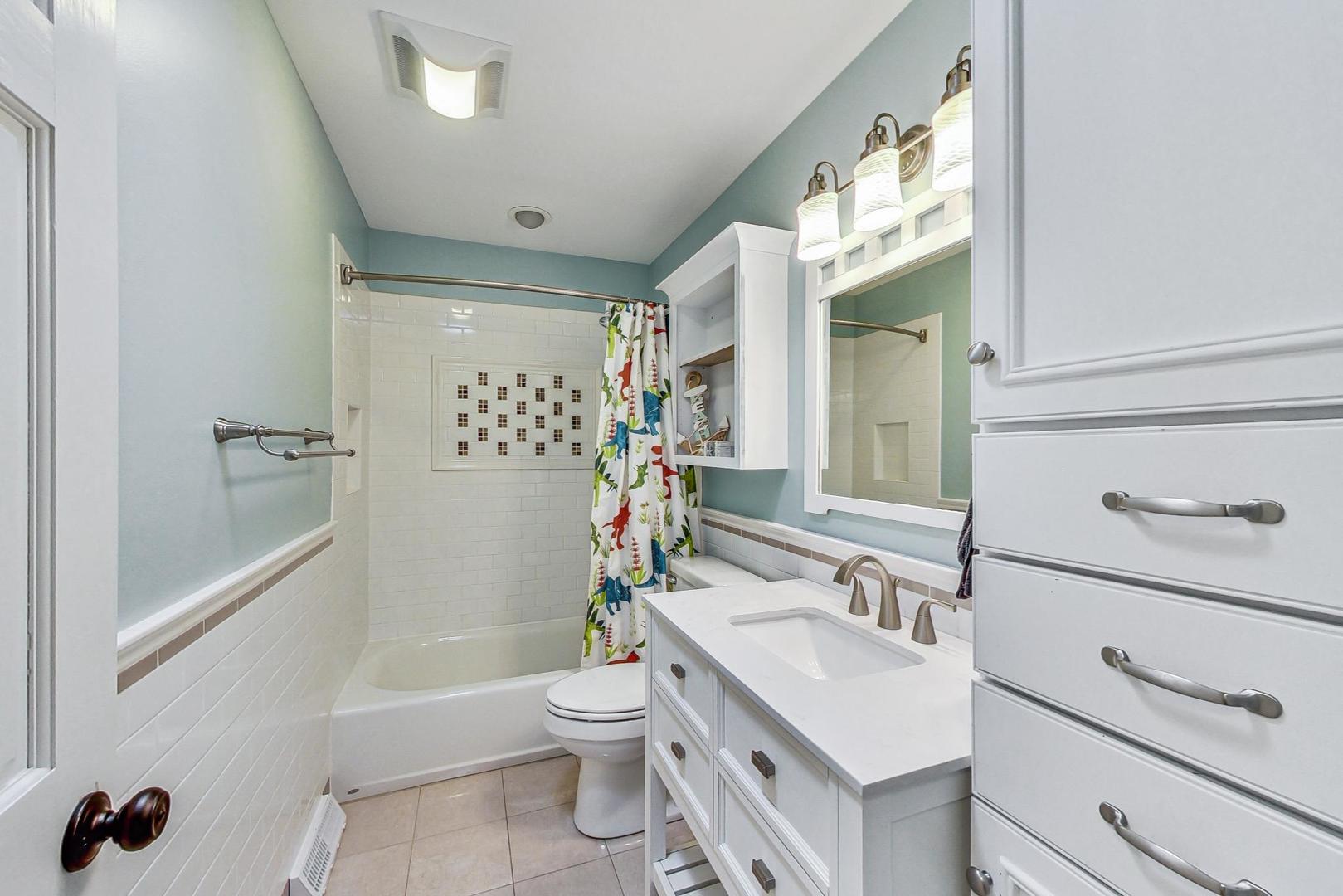 837 Foster Avenue Bartlett, IL 60103 - Photo 23 of 46 a bathroom with a sink toilet and shower