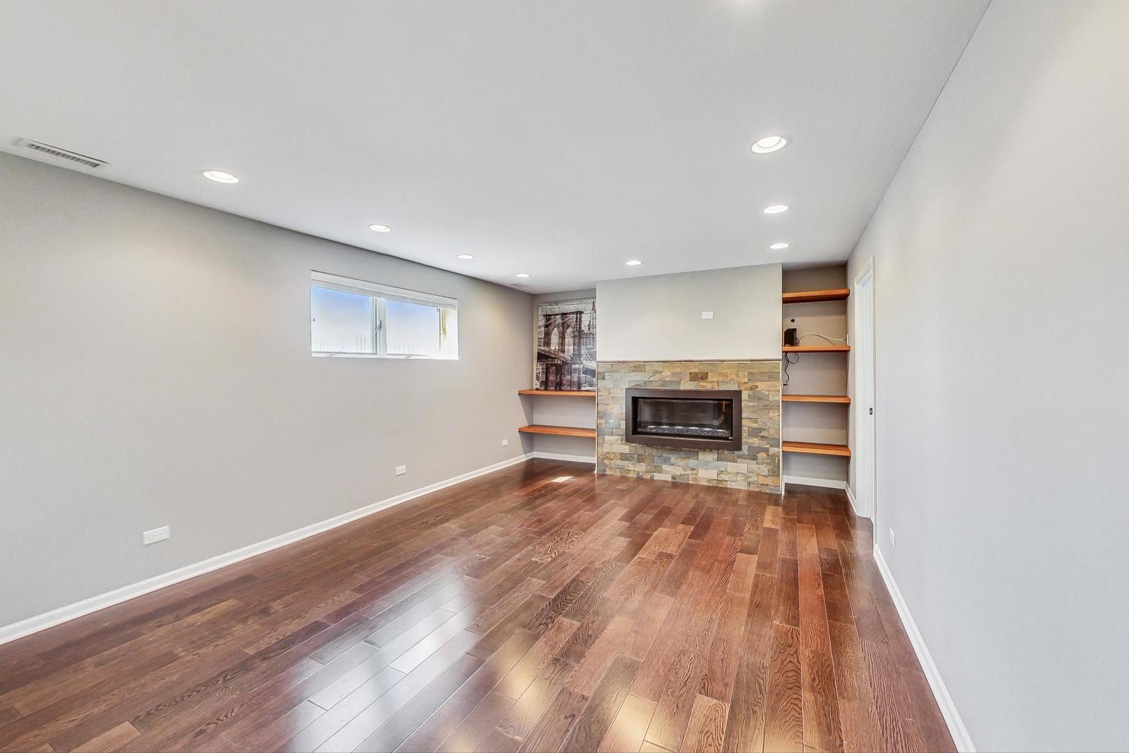 837 Foster Avenue Bartlett, IL 60103 - Photo 24 of 46 a view of empty room with wooden floor and fireplace