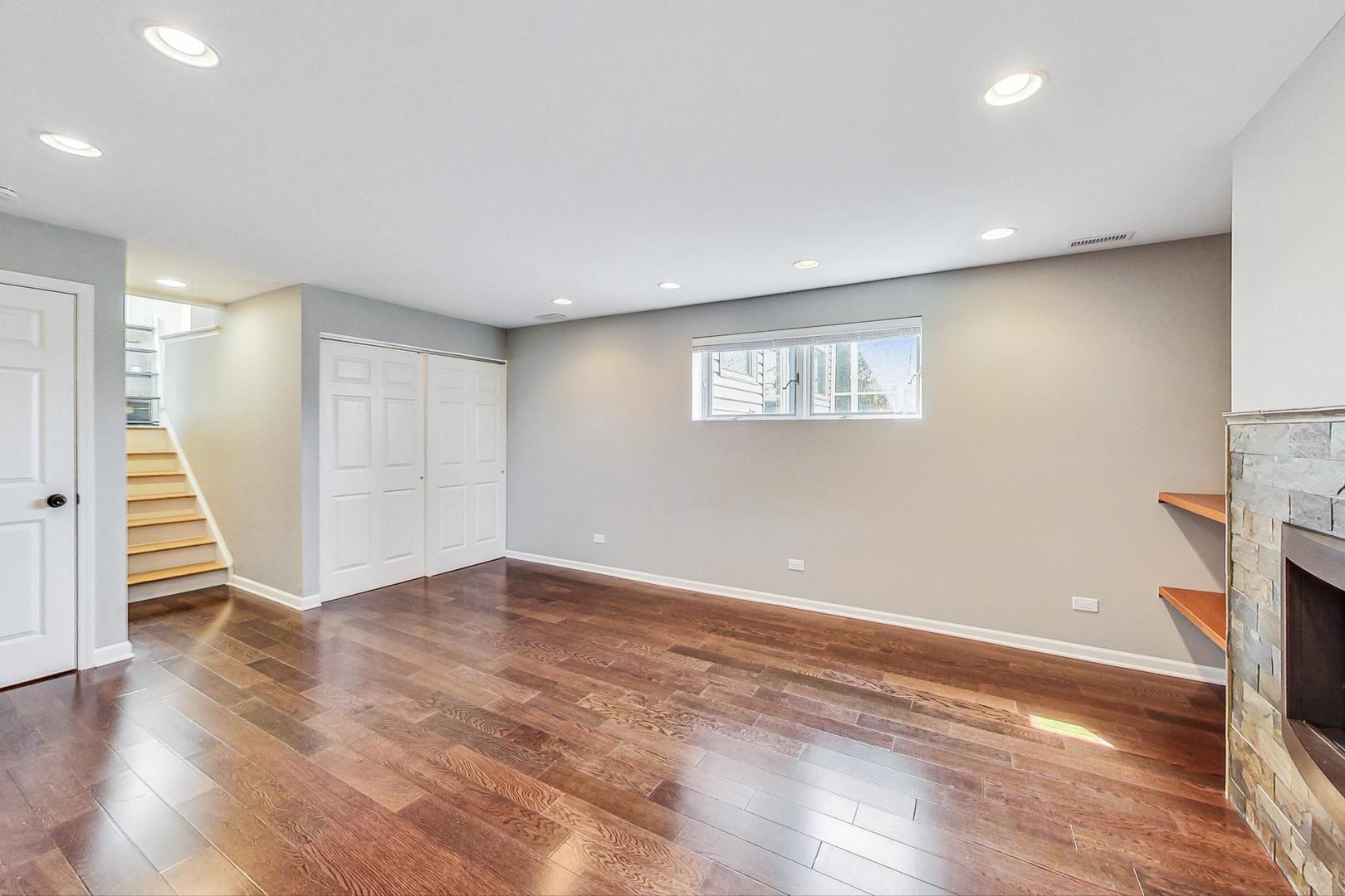 837 Foster Avenue Bartlett, IL 60103 - Photo 26 of 46 a view of an empty room with wooden floor and stairs