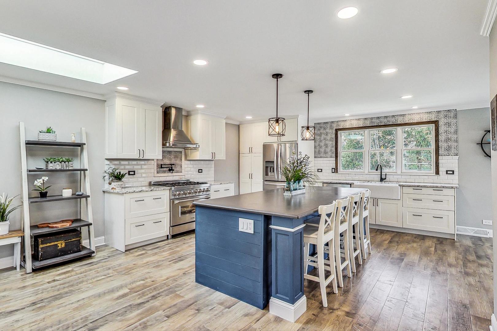 837 Foster Avenue Bartlett, IL 60103 - Photo 3 of 46 a kitchen with stainless steel appliances kitchen island granite countertop a large window and white cabinets