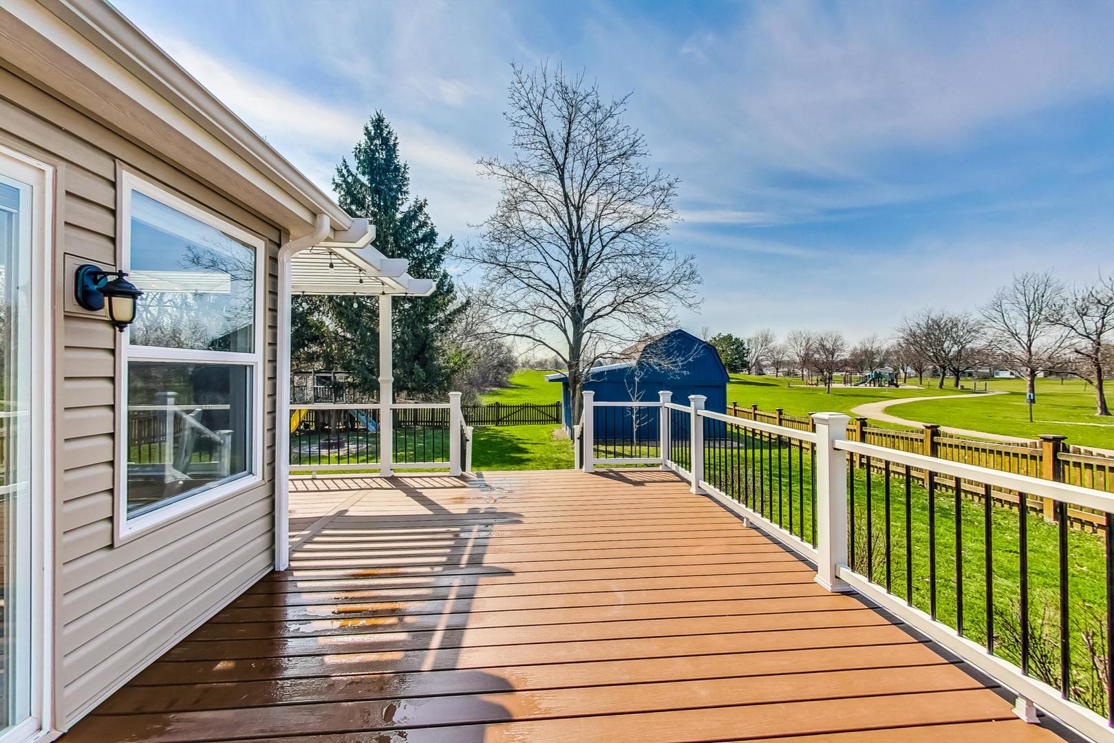 837 Foster Avenue Bartlett, IL 60103 - Photo 34 of 46 a view of a balcony with wooden floor and fence