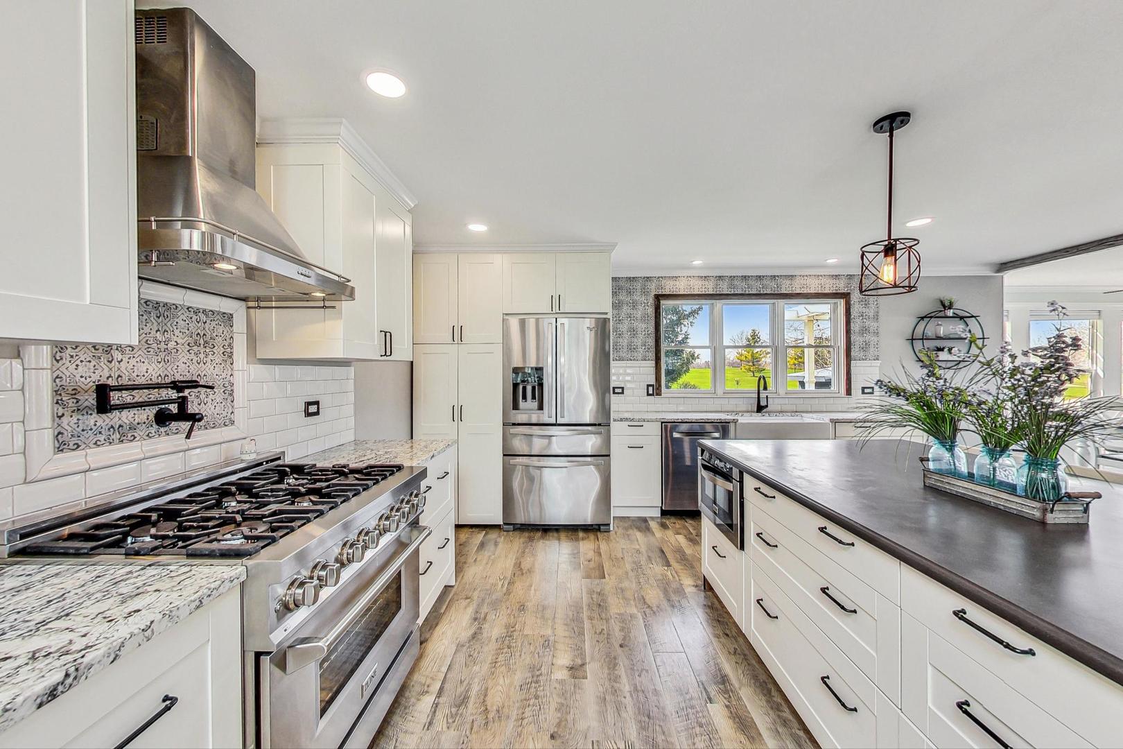 837 Foster Avenue Bartlett, IL 60103 - Photo 4 of 46 a kitchen with stove and refrigerator