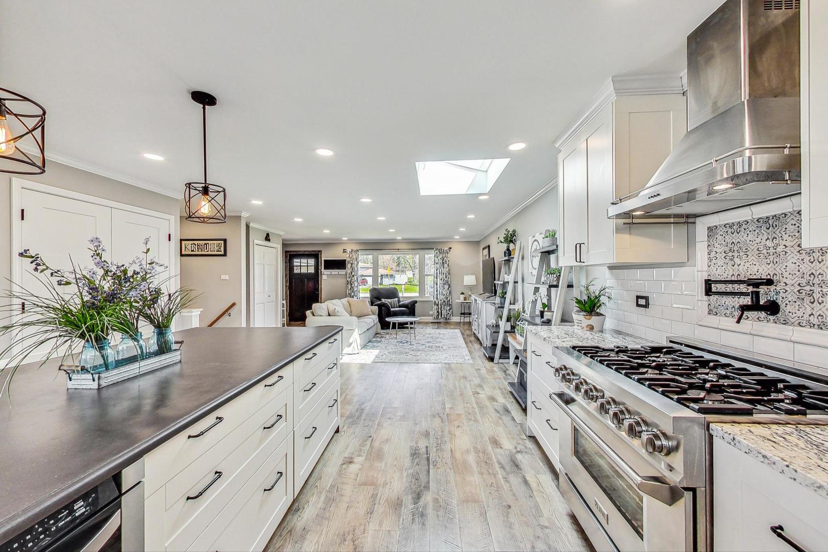 837 Foster Avenue Bartlett, IL 60103 - Photo 5 of 46 a kitchen with sink stove and cabinets