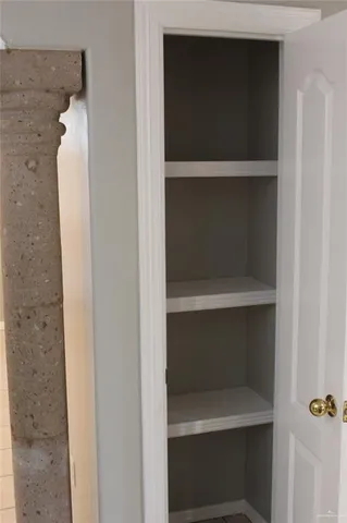 a view of a livingroom with a large window wooden floor and front door