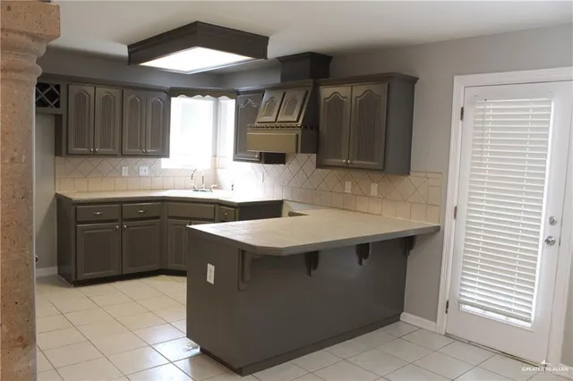 a kitchen with a sink cabinets and wooden floor