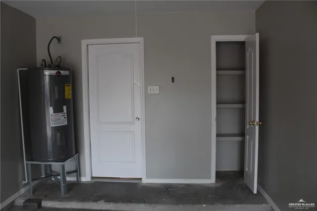 a view of a backyard with a large tree and wooden fence